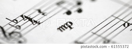 Musical notes printed on paper sheet 61555372