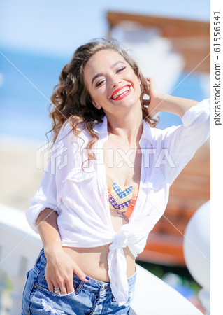 Luxury vacation of a young female model smiling and enjoying life 61556541
