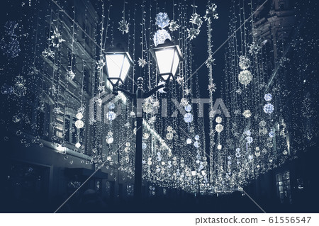 Abstract monochromatic Christmas street with illumination, burning lantern closeup, Christmastide, modern background, fashion color Abstract monochromatic Christmas street with illumination, burning lantern closeup, Christmastide, modern background, fashion color 61556547