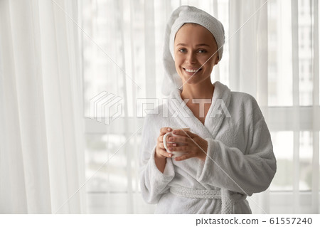 Girl in bathrobe holding cup with coffee. - Stock Photo [61557240] - PIXTA