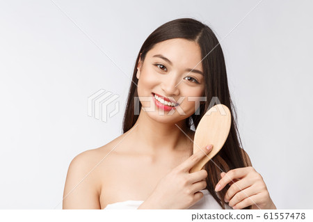 portrait of a beautiful young woman comb wonderful hair isolated on white background, asian beauty portrait of a beautiful young woman comb wonderful hair isolated on white background, asian beauty 61557478