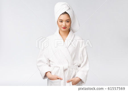 Portrait of a young happy asian lady in bathrobe.Isolated in white background. 61557569