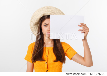Young caucasian woman holding blank paper sheet over isolated background scared in shock with a surprise face, afraid and excited. Young caucasian woman holding blank paper sheet over isolated background scared in shock with a surprise face, afraid and excited. 61557638