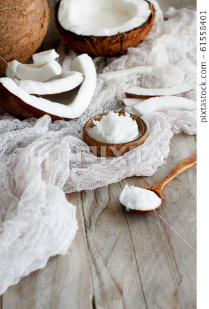 Coconut oil in a bowl with a spoon Coconut oil in a bowl with a spoon 61558401