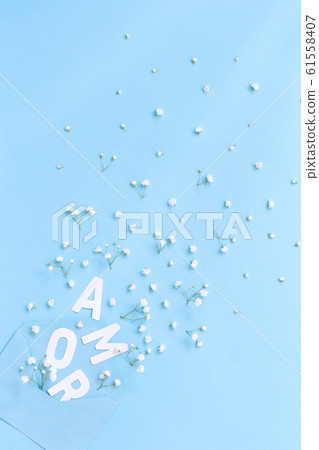 Blue envelope, text AMOR and small white flowers Blue envelope, text AMOR and small white flowers 61558407