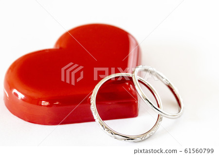 Pair of wedding rings and red heart Pair of wedding rings and red heart 61560799
