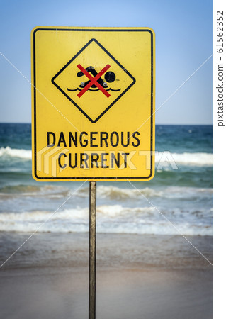 Warning sign for swimmers to beware dangerous currents Warning sign for swimmers to beware dangerous currents 61562352