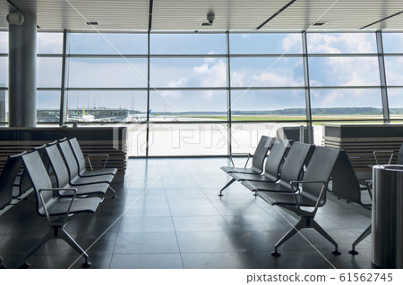 Empty chairs at waiting area in the airport terminal. Empty chairs at waiting area in the airport terminal. 61562745