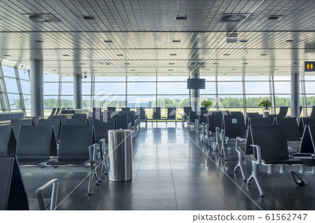 Modern airport waiting hall interior with empty chairs. Modern airport waiting hall interior with empty chairs. 61562747