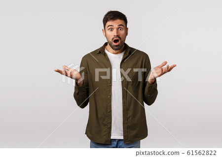 Whats big deal. Guy waiting for explanation cant figure out what happened. Puzzled, alarmed, worried frustrated handsome bearded man trying solve situation, shrugging with hands sideways questioned 61562822