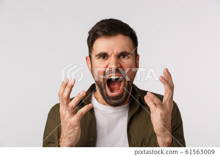 Man losing temper feeling aggression and depression. Distressed and bothered bearded male fed up, tired of arguing shouting, shaking hands aggressive and cursing someone, look angry, white background Man losing temper feeling aggression and depression. Distressed and bothered bearded male fed up, tired of arguing shouting, shaking hands aggressive and cursing someone, look angry, white background 61563009