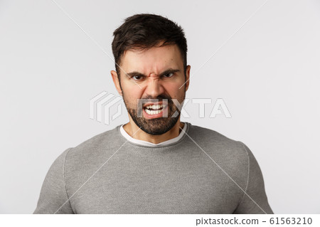 Rage, aggression and hate concept. Outraged and furious bearded adult man frowning, grimacing stare bothered and disgusted, express scorn or disdain, cursing someone want fight, white background 61563210