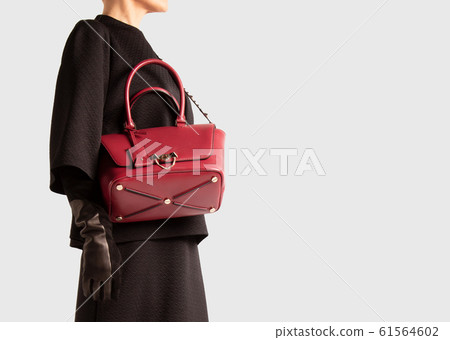 Woman with a red bag over her shoulder. Luxury 61564602