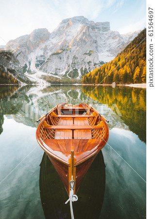 Traditional rowing boat on alpine lake in fall 61564697