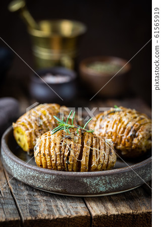 Baked hasselback potatoes 61565919