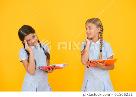 Nervous kids. Cute children reading book on yellow 61566231