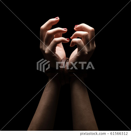 Woman tied up with leather belt in emotional 61566312