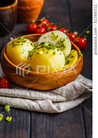 Boiled potatoes with greens in a wooden bowl Boiled potatoes with greens in a wooden bowl 61566511