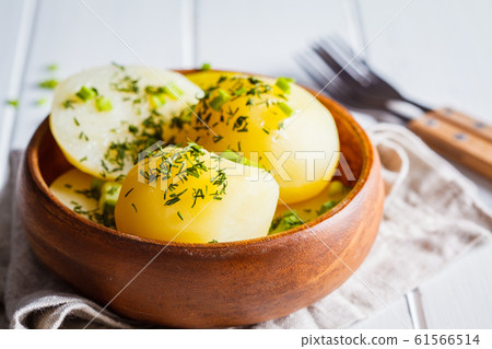 Boiled potatoes with greens in a wooden bow Boiled potatoes with greens in a wooden bow 61566514