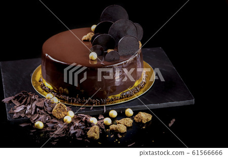 Fancy mirror glaze chocolate cake on dark background 61566666