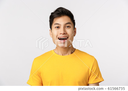Close-up studio shot, amused cute asian guy smiling as seeing something wonderful, look enthusiastic and impressed, attend beautiful interesting performance, standing entertained white background Close-up studio shot, amused cute asian guy smiling as seeing something wonderful, look enthusiastic and impressed, attend beautiful interesting performance, standing entertained white background 61566735