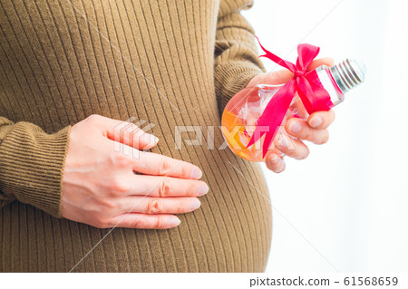 Pregnant woman with herbarium gift 61568659