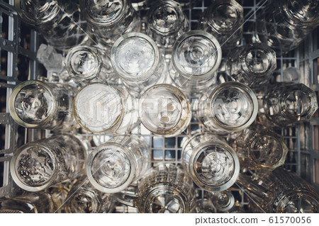Close-up photo of clean washed and polished bar and pub glasses hanging over Empty glasses ware on table in night club with reflection Empty clean bar glasses Close-up photo of clean washed and polished bar and pub glasses hanging over Empty glasses ware on table in night club with reflection Empty clean bar glasses 61570056