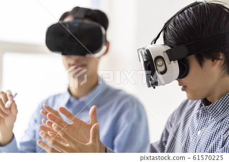 兩名男子通過VR護目鏡體驗3D最新5G技術並將其納入業務 兩名男子通過VR護目鏡體驗3D最新5G技術並將其納入業務 61570225