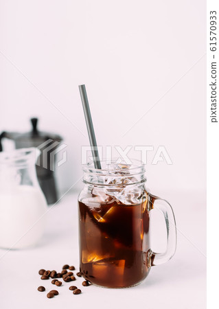 Iced coffee drink on glass jar with straw. Iced coffee drink on glass jar with straw. 61570933