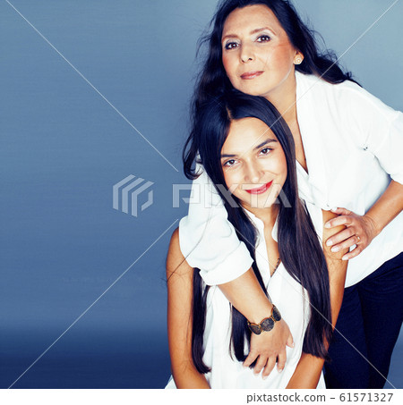 cute pretty teen daughter with mature mother hugging, fashion style brunette, lifestyle people concept cute pretty teen daughter with mature mother hugging, fashion style brunette, lifestyle people concept 61571327