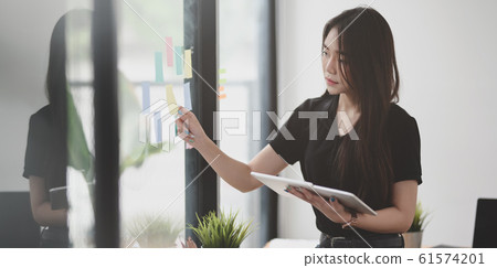 Beautiful female freelancer picking up the idea Beautiful female freelancer picking up the idea 61574201