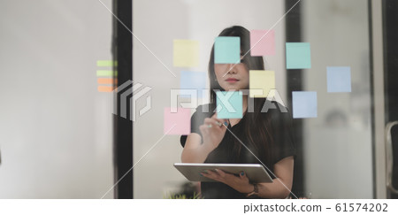 Freelancer collecting the idea from sticky note Freelancer collecting the idea from sticky note 61574202