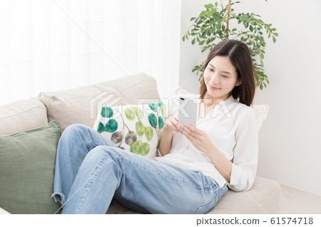 Young woman, smartphone, sofa 61574718
