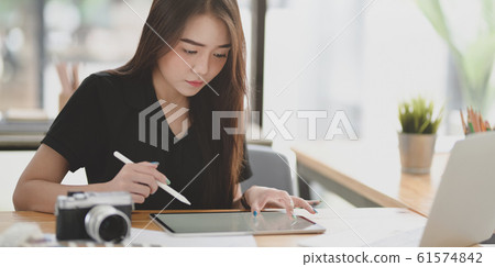 Young professional female designer working on her 61574842