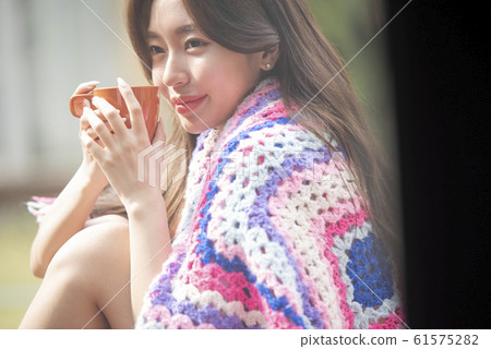 Woman with mug outdoors 61575282
