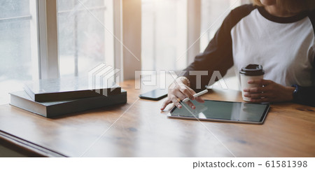 Close-up view of female freelancer writing her Close-up view of female freelancer writing her 61581398