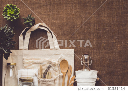 Collection of various succulent plants and Mesh market bag with bamboo cutlery, reusable bottles and eco cotton bags on wooden background Collection of various succulent plants and Mesh market bag with bamboo cutlery, reusable bottles and eco cotton bags on wooden background 61581414