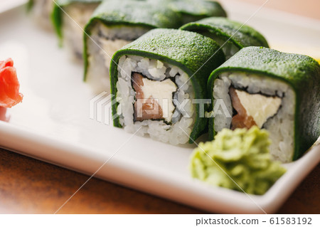 Traditional Japanese cuisine. Sushi with salmon and cheese are ready to be served. Delicious Japanese food. 61583192