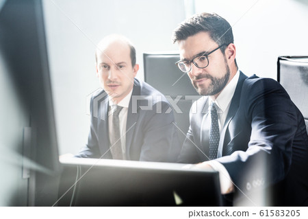 Business team analyzing data at business meeting in modern corporate office. 61583205