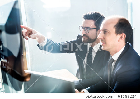Business team analyzing data at business meeting in modern corporate office. 61583224