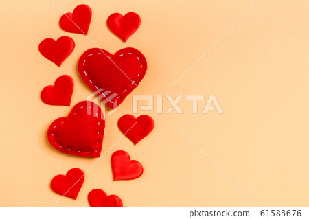 Top view of red textile hearts on colorful 61583676