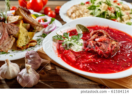 Red beet vegetable soup borscht on wooden background. Ukrainian and russian national food. Close-up. Red beet vegetable soup borscht on wooden background. Ukrainian and russian national food. Close-up. 61584114