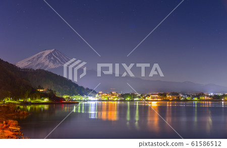 Beautiful landscape view of Fuji Mountain and Kawaguchiko lake at night from Yamanashi Prefecture, Japan. Beautiful landscape view of Fuji Mountain and Kawaguchiko lake at night from Yamanashi Prefecture, Japan. 61586512