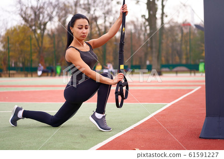 Girl athlete functional training on sportground. Girl athlete functional training on sportground. 61591227