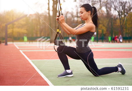 Girl athlete functional training on sportground. 61591231