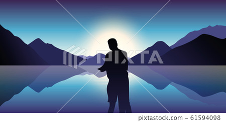 couple in love enjoy the blue mountain and ocean landscape in the dusk couple in love enjoy the blue mountain and ocean landscape in the dusk 61594098