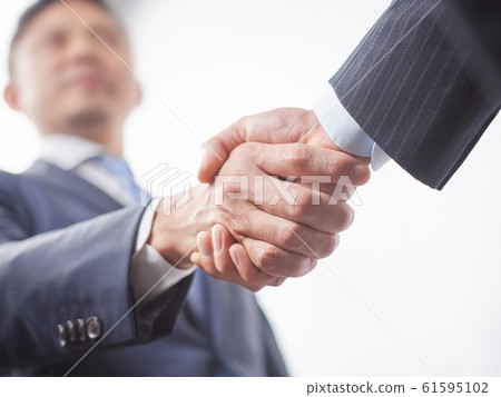 Male businessman shaking hands 61595102