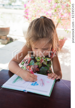 Adorable little girl drawing artwork top view on Adorable little girl drawing artwork top view on 61595545