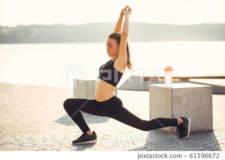 Beautiful sports girl in a summer park 61596672