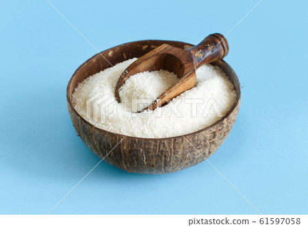 Coconut flour in a bowl with a spoon on a light Coconut flour in a bowl with a spoon on a light 61597058